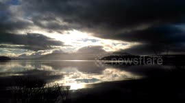 Dramatic skies over a tranquil Lake Windermere