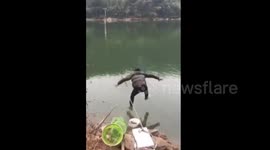 Man jumps into river to chase rod dragged away by fish