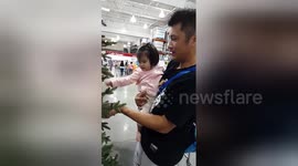 Baby fascinated first time she sees Christmas tree