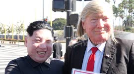 Man in Trump mask shakes hands with 'Kim Jong-un'