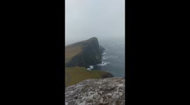 Waterfall flowing backwards in high winds at Neist Point on Isle of Skye during Storm Caroline
