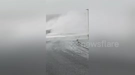 Massive waves break over sea wall in Orkney
