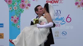 Groom kissing bride in Thailand