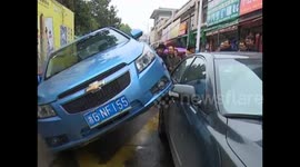 Car ends up on side in bizarre slow-speed crash