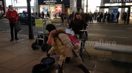 A young girl busking during Black Friday in Oxford street, London, UK