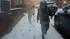 Children run out into snowy street