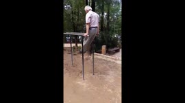 Old man doing gymnastics at park in Albania