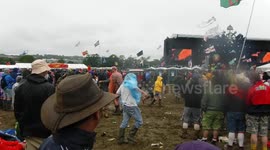 The drunkest guy in the World struggles to put his Poncho on at Glastonbury Festival