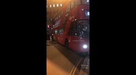 London bus gets stuck on centre verge having taken the corner too sharply