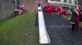Santacon 2017: A Large Santa Attempts To Go Down A Slide In Tower Hill