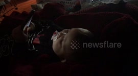Funny baby turns phone sideways to see movie better