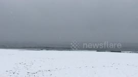 East Coast storm brings snow to beach