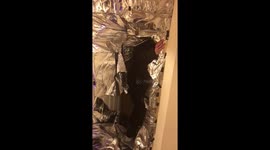 Men cover friend's door with tin foil for birthday