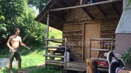 Guy throw an axe and land the side of a log / WIN