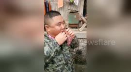 Man eats raw meat fresh from the carcass in southern China