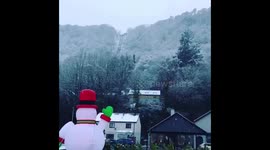 Santa surfing in the mountains and in the snow