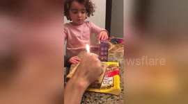 Boy struggles to blow out birthday cake candle