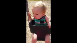 Baby's first time swinging