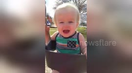 Baby has cutest reaction to first-ever swing ride