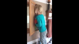 Girl hides her face after using her mother's make up