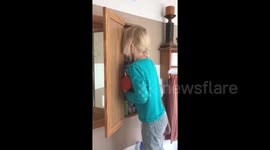 Girl hides her face after using her mother's make up