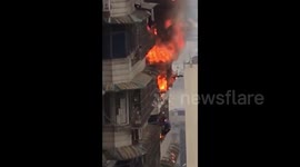 Man hangs out 23rd floor window after escaping from ablaze flat