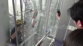 Tourist hanging upside down at airport