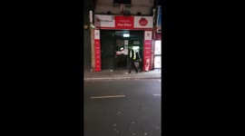 Man enters shop walking backwards in London