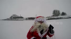 Santa goes sledging in snowy Buxton, UK