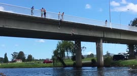 Australian children jumping off bridge into river