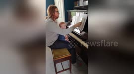 Newsflare Edit - Baby waits for page to turn before playing piano