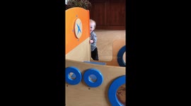 Toddler playing peekaboo for the first time