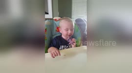 Toddler falls asleep as he eats ice cream