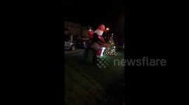 Woman takes out inflatable Santa at party