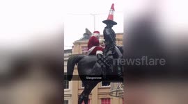 Glasgow Santa waves to crowd before being removed by police