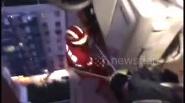 Firefighters rescue man hanging from 16th floor window