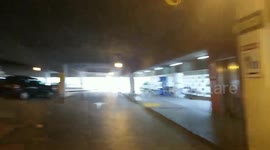lax airport police K9 dog  Sits down by a  Bag
