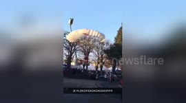 Santa Claus arrives by parachute to Christmas market in France