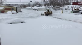 Snow in parking lot being cleared
