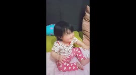 10 m baby is fighting for the candy and try to hide it
