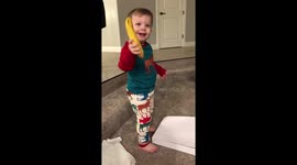 Two-year-old is thrilled with a banana for Christmas