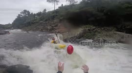 Kayaker catches football one-handed while riding 12ft waterfall