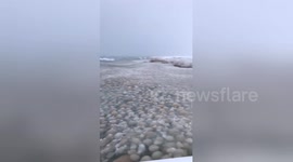 Huge ice balls roll on to Lake Michigan