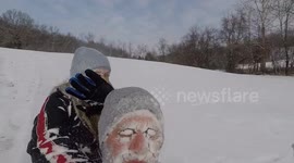 Brother and sister get faces full of snow when out sledding
