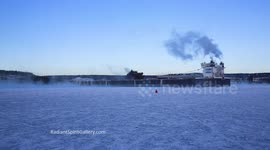Huge ore boat makes its way through frozen Lake Superior