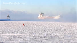 Ship arrives through sea smoke on Lake Superior in brutal cold snap