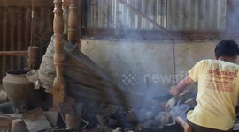 Bellows pumping at a silverworks shop in Mandalay, Myanmar