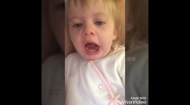 Baby pulling funny faces at herself on the camera