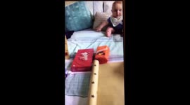 Cute baby goes crazy over mother wrapping presents