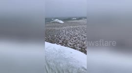 Newsflare Edit - Ice balls in Lake Michigan at St. Joseph lighthouse pier Video #2